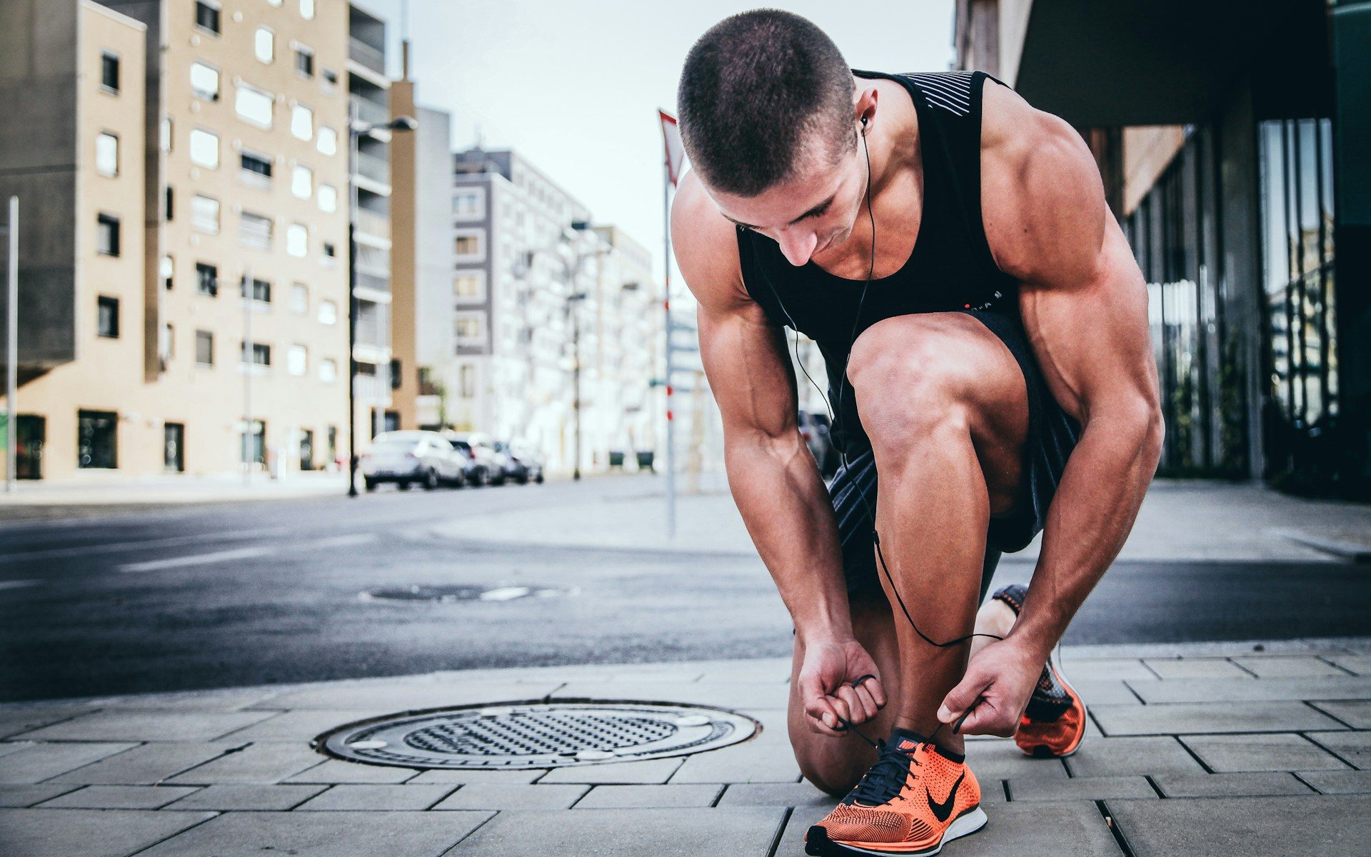 man tying his shoes about to go for a run - Contact I Stay Fit