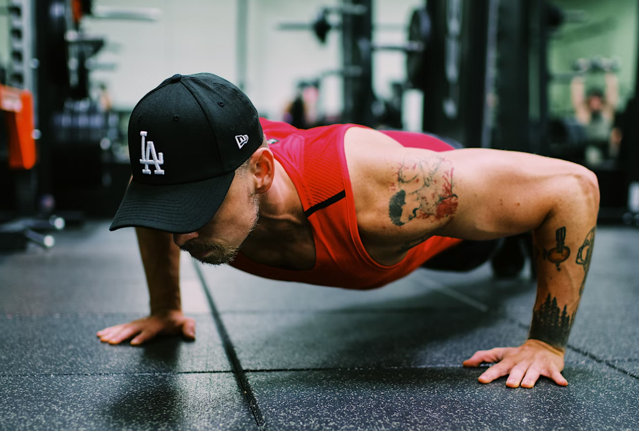 man doing pushups in a gym - the murph workout