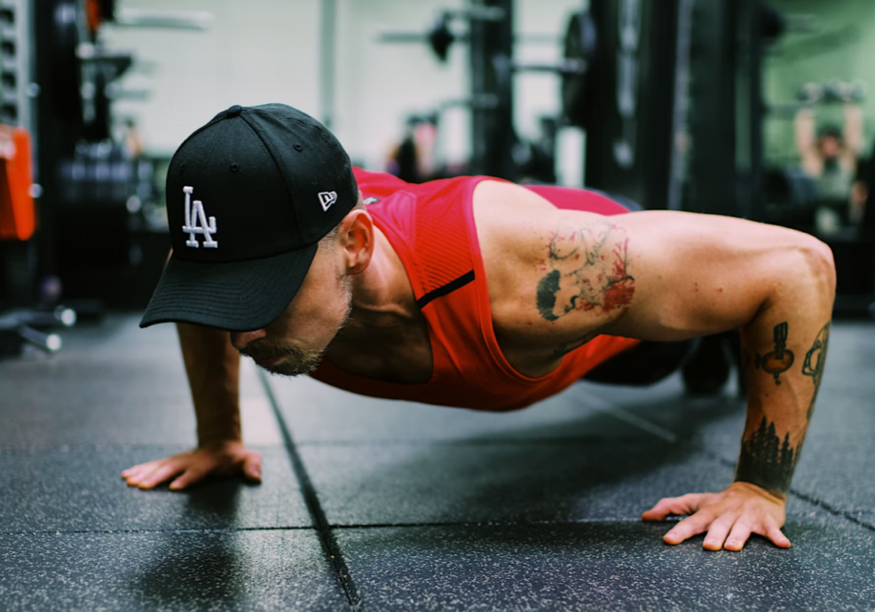 man doing pushups in a gym